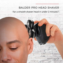 Electric head shaver used on a man's face, black foil head for close shaving
