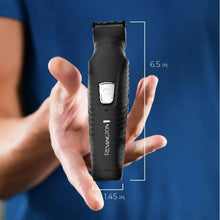 Black REMINGTON head and body trimmer held in hand