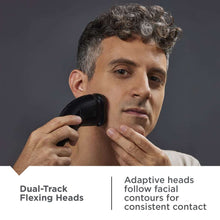 Men's rotary shaver held against the chin for close shave contact