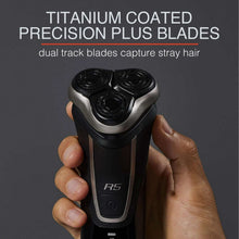 REMINGTON R5 rotary shaver held in a hand, three circular heads with silver trim