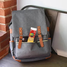 Gray backpack with RITZ cheese cracker sandwich box in front pocket