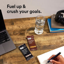Hand holding an RXBAR protein bar with two bars on a desk