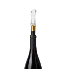 Wine aerator stopper with clear tube and black collar, gold accents