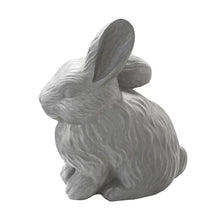 Gray rabbit statue, side view with long ears and curled body, textured fur.