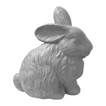Gray rabbit statue, angled rear view with long ears and sculpted fur details.