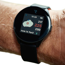 Golf GPS watch on wrist, black round screen showing course stats