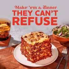 Lasagna serving with “THEY CAN’T REFUSE” text over a dinner table
