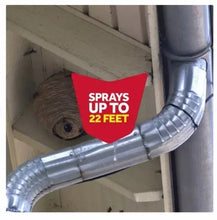 Metal spray hose at house eave with red 'SPRAYS UP TO 22 FEET' marker