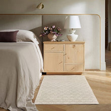 Light gray accent rug with subtle repeating geometric pattern, flat woven look.