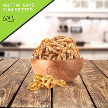 Raw walnut halves and pieces in a wooden bowl, unsalted and shelled
