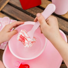 Pink silicone fork and spoon with cake in a kidsâ€™ dish