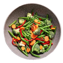 Bowl of mixed vegetables with green beans, broccoli, carrot slices, and red peppers