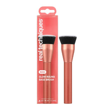 Makeup base brush with rounded head and black bristles on rose-gold handle