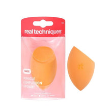 Orange teardrop Miracle Complexion Sponge shown with package and loose sponge