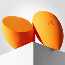 Two orange teardrop makeup sponges with 'rt' logo