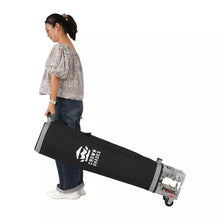 Shade carry bag with wheels and handle being carried by a person