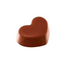 Chocolate peanut butter mini heart candy, smooth unwrapped brown surface