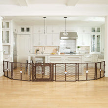 Brown plastic play yard gate with door set up in a bright living room