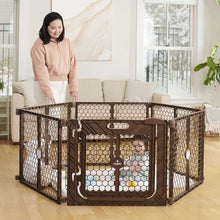 Brown superwide plastic play yard gate surrounding a living room, with door panel
