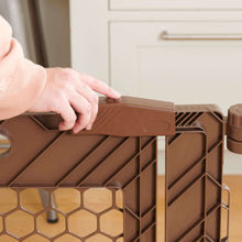 Brown plastic gate panel with top latch tab and hinge connection detail