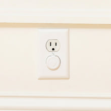 White outlet safety plug and socket cover on a wall plate