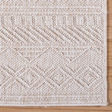 Beige area rug close-up with raised geometric weave and serged edge