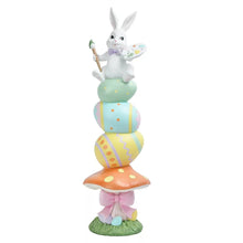 Resin stacked door greeter bunny with paint palette and brush, pastel spring layers on grass