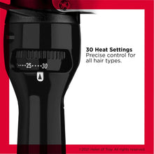 Black curling iron heat control dial with setting markers on the body.