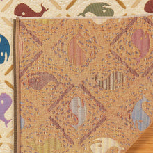 Close-up of rug edge and woven surface with fish motif pattern