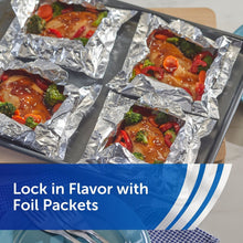 Aluminum foil packets in a sheet pan with saucy vegetables and chicken