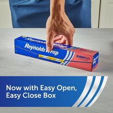Hand reaching for a Reynolds Wrap Every Day aluminum foil box on a countertop