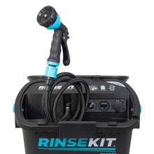 Portable handheld shower head with black hose stored in open unit
