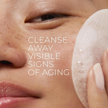 White exfoliating makeup remover pad gently pressed against facial skin