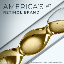 Golden retinol serum droplets on a spoon-like applicator
