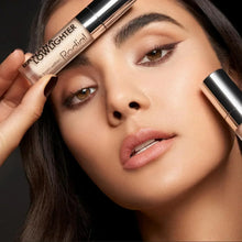 Rodial lowlighter tubes held near face, showing beige shimmer tint