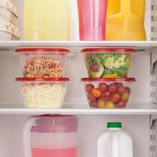 Clear square food storage containers with red lids on refrigerator shelves.