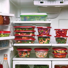 Clear food storage containers with red lids arranged in a freezer