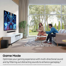 Home theater soundbar setup with TV and small black subwoofer speaker