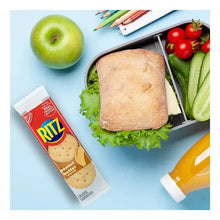 Peanut butter cracker sandwiches pack beside sliced sandwich and vegetables