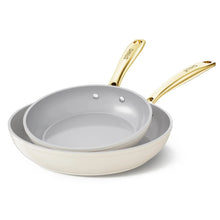 2-piece nonstick frying pan set with grey interiors and gold handles, beige rims