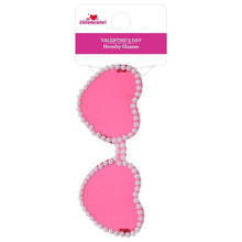 Pink heart-shaped glasses with rhinestone trim, on display card