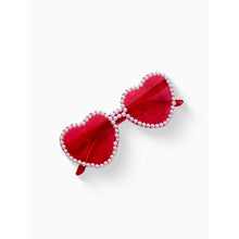 Pink heart-shaped glasses with red-tinted lenses and rhinestone trim