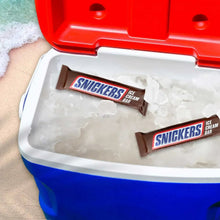 SNICKERS ice cream bars resting on crushed ice in a white tray