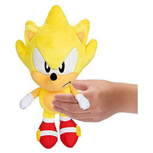 Yellow Sonic-style plush doll being held by a hand, showing face and white gloves