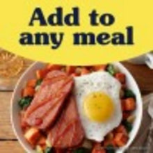 Serving plate with fried egg, sliced meat, and mixed vegetables