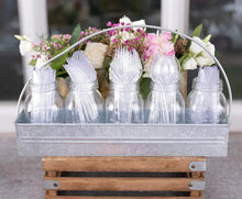 Clear plastic disposable spoons and forks standing in a serving tray