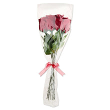 Dark red rose bouquet wrapped in white tulle with pink ribbon bow