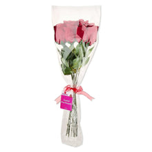 Dark red rose bouquet in white wrap with pink ribbon and label