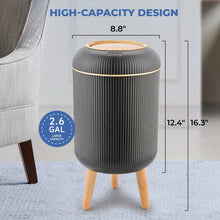 Black automatic trash can with ridged body, closed round lid, and wooden legs