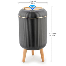 Black automatic trash can with round lid, ridged sides, and wooden legs